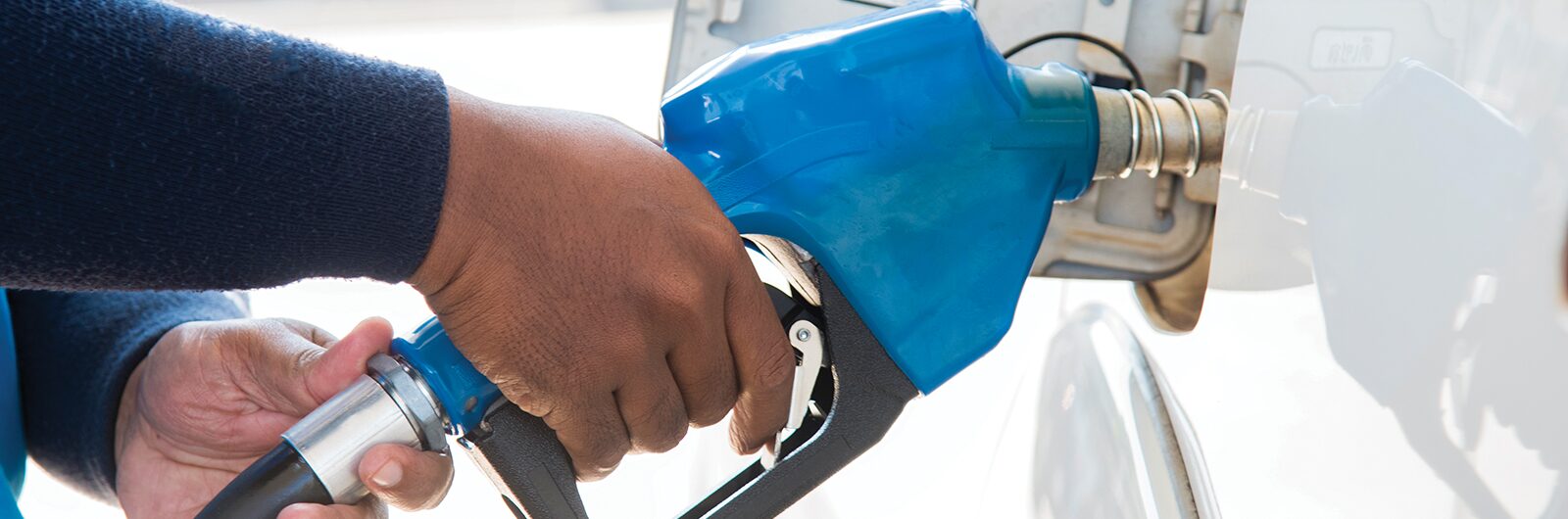 A person pumping gas into their vehicle.