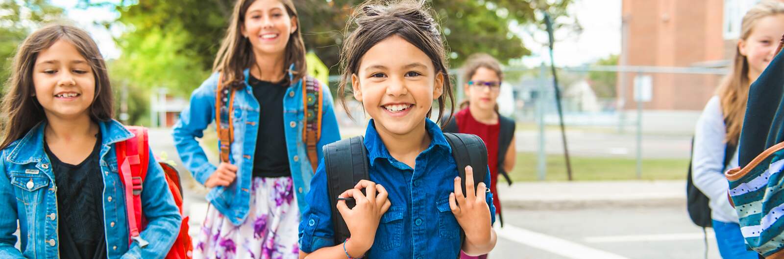 Children crossing the street going to school.
