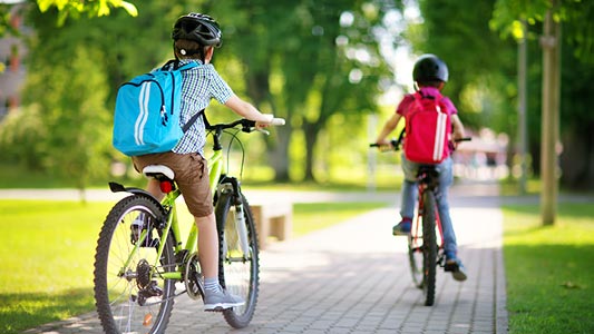 Children riding their bicycles to school.