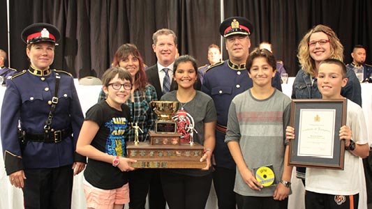 A group of school safety patrollers and their awards.