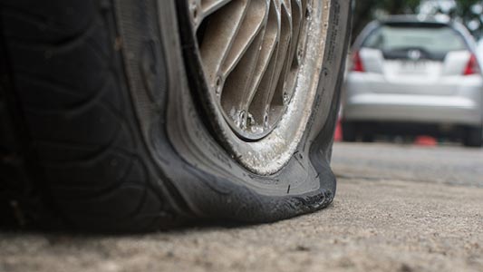 A vehicle with a flat tire.