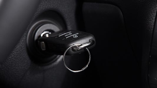 A car key in the ignition of a vehicle.