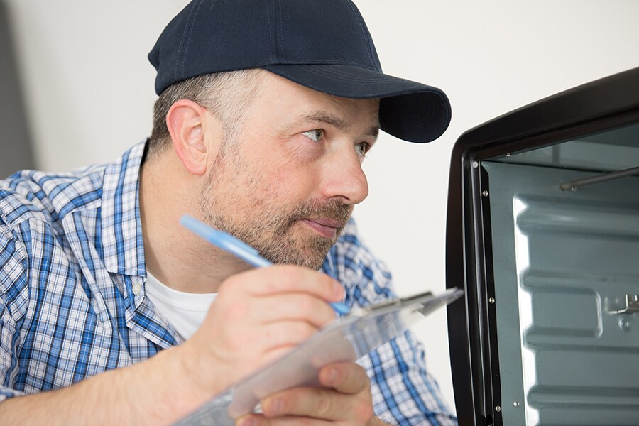 A man writing on a clipboard.