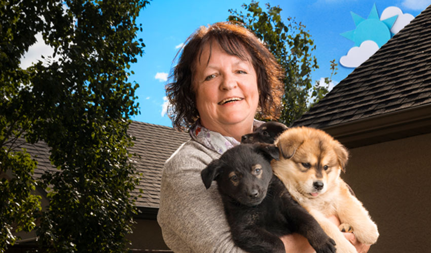 Woman holding two puppies