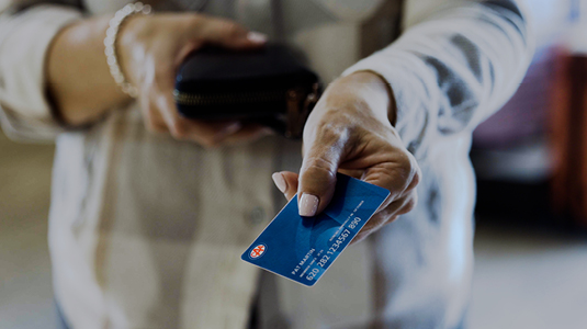 Person handing a CAA Membership card