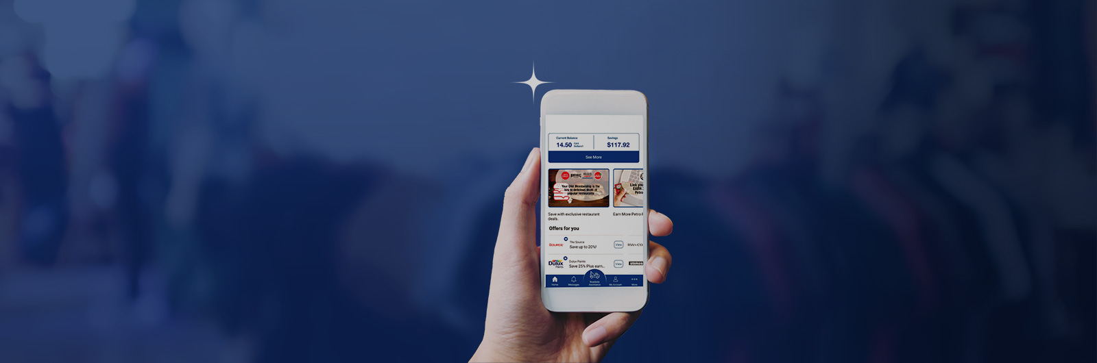 Image showing hand holding up smartphone with various symbols on the screen against a navy blue background.