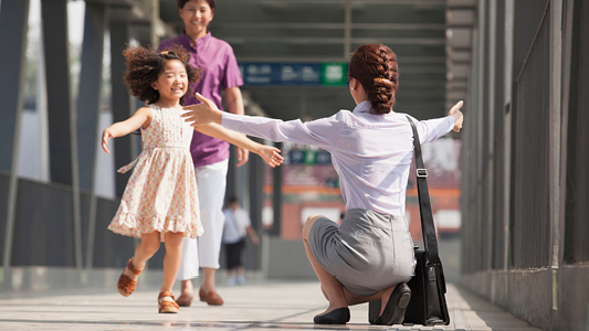 Child running to hug her mother at the airport.