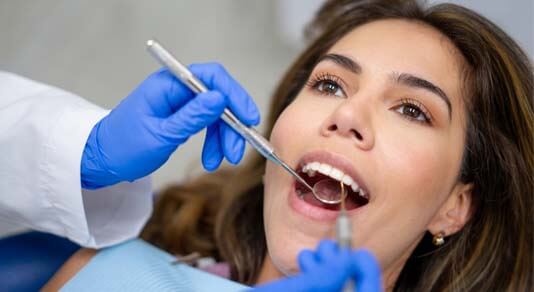 Patient at the dentist getting her teeth cleaned