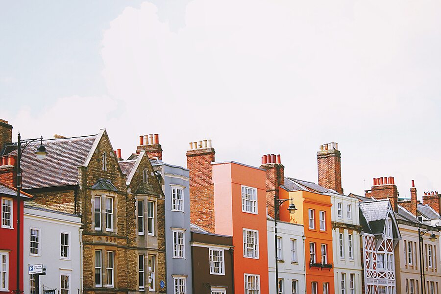 Image showing a line of colourfully painted houses and buildings on a street.
