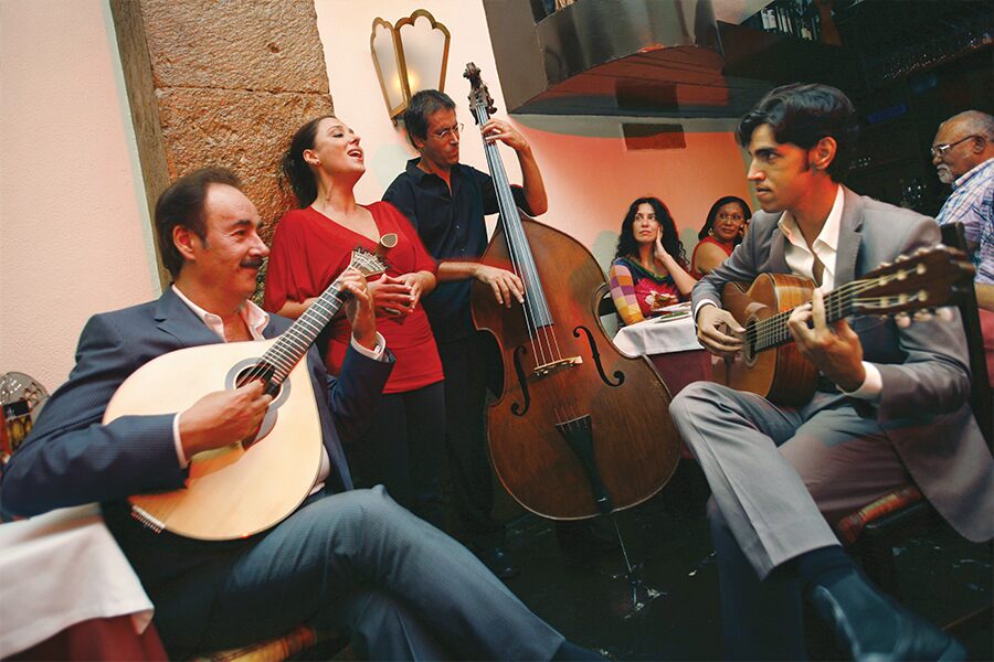 Photo showing a collection of musicians playing on a street in Lisbon.