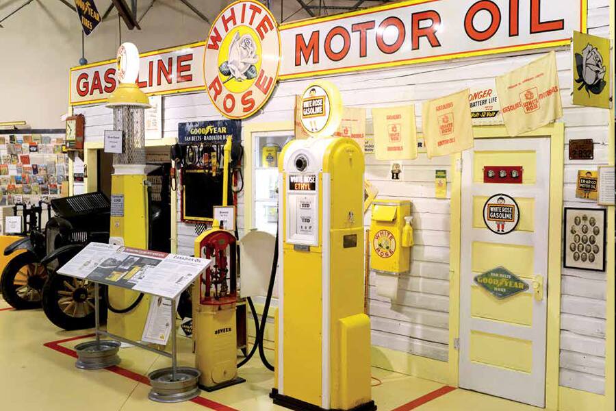 Photo showing a collection of gasoline pumps, signs and other oil industry memorabilia.