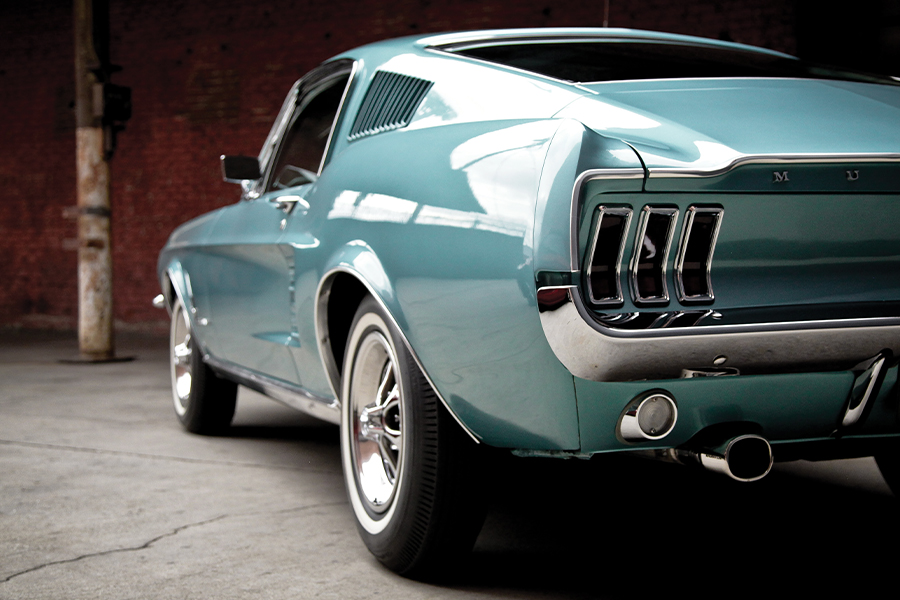 photo showing rear three-quarter view of 1968 Ford Mustang fastback in turquoise blue colour.