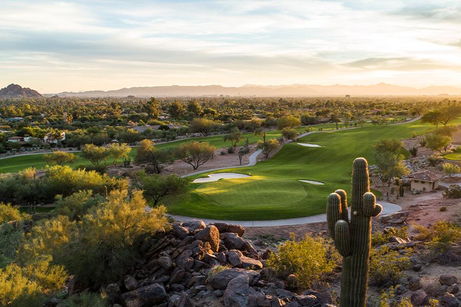 Image showing green golf course with cactus and small river winding by.