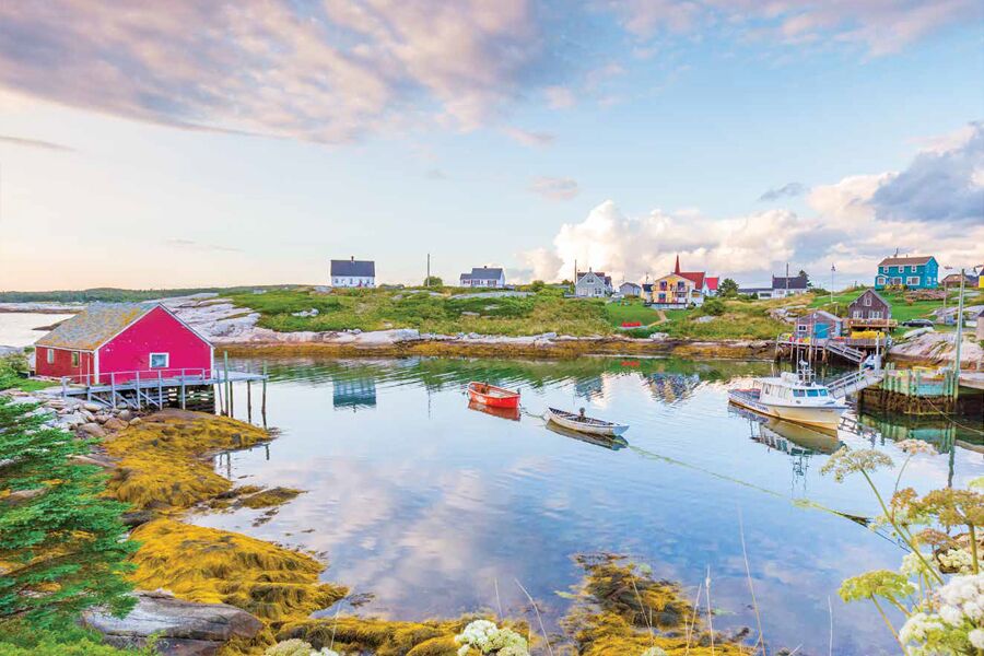Photo showing typical Atlantic Canada harbour scene, with red outbuildings and small boats.