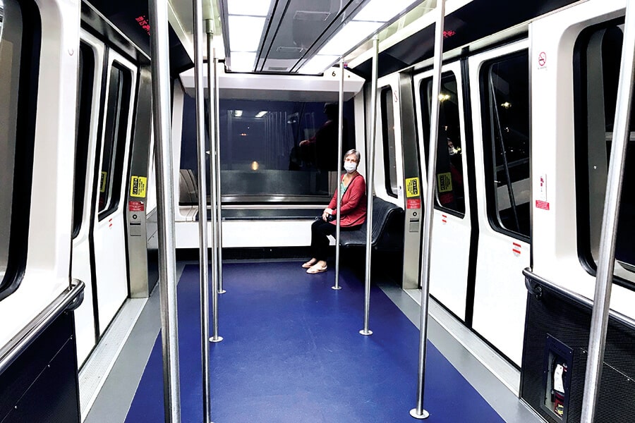 Image showing inside of typical urban rapid transit rail car with lone passenger sitting in background.