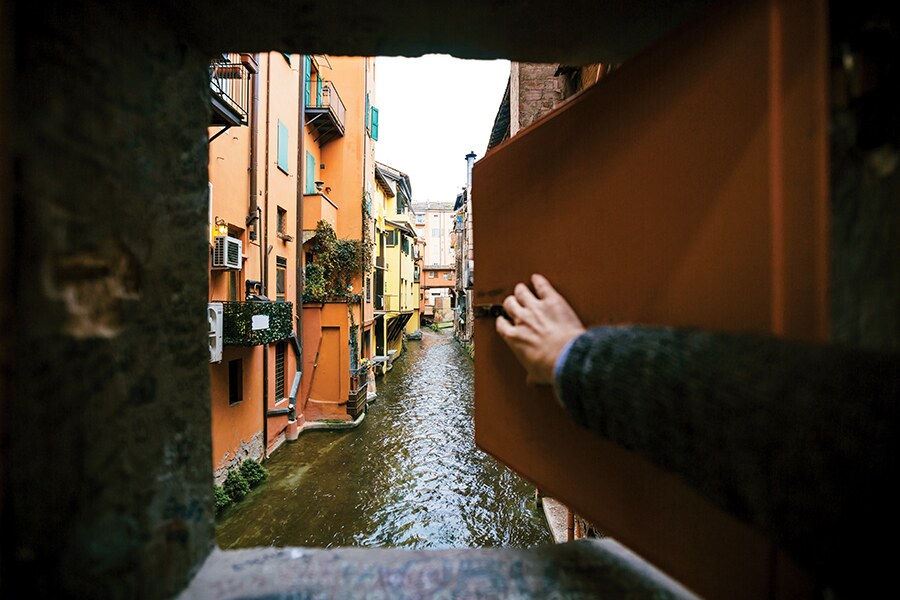 Image showing a view of a Venetian canal through an open window.