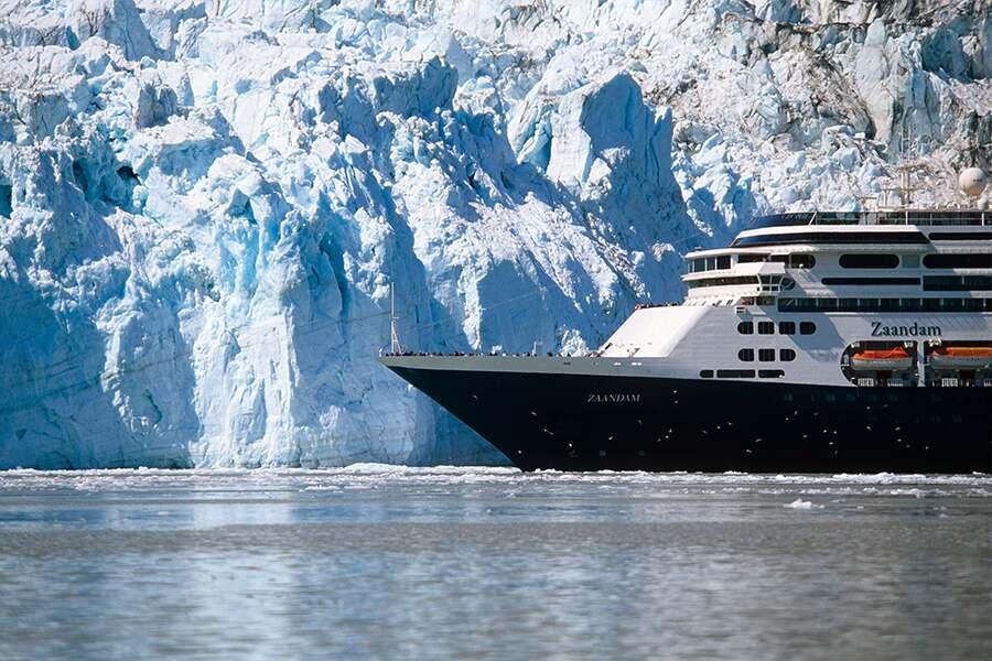 Image showing bow of large cruise ship floating in sea ice beside a glacier.