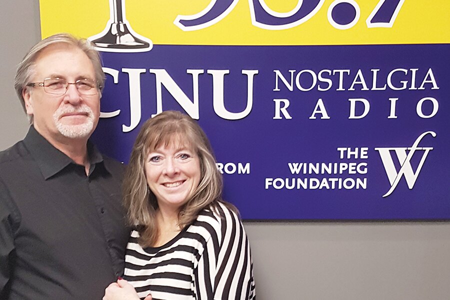 Photo showing male and female CAA Members standing in front of a sign reading CJNU Nostalgia Radio.