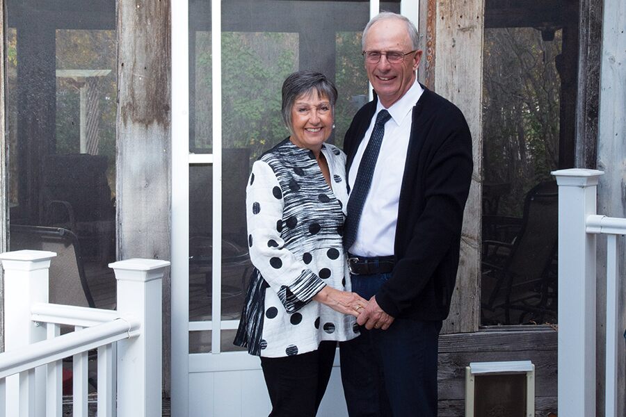 Image showing a middle-aged couple standing facing the camera and smiling.