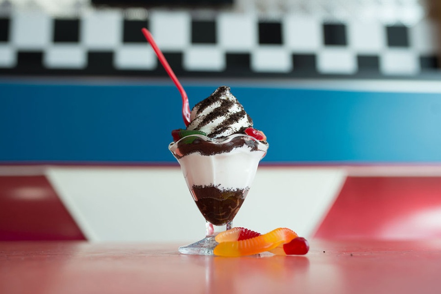Images showing ice cream treat with vanilla ice cream and crushed oreo cookies.
