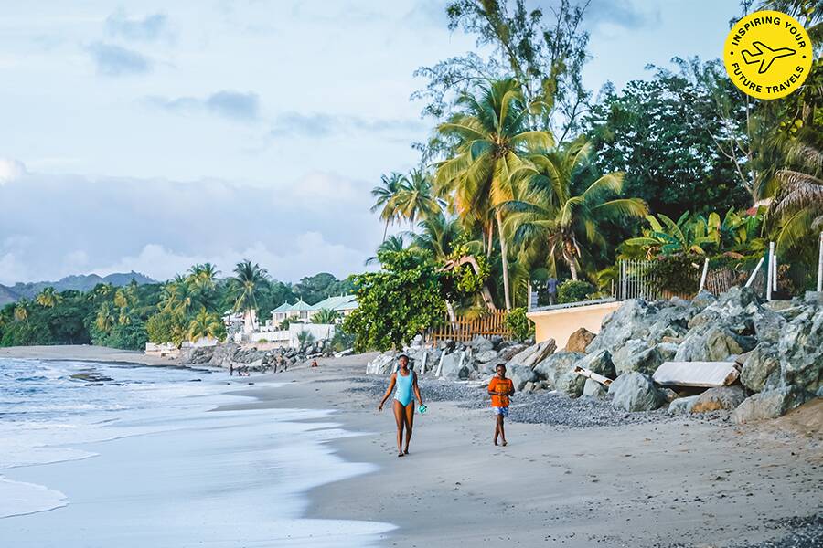 Image showing two people walking along a beach in Tobago.