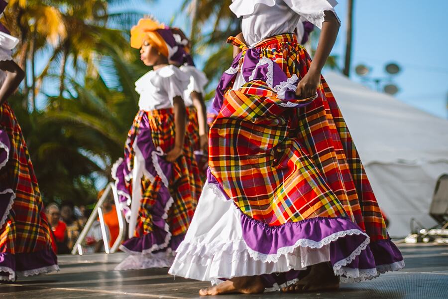 Image showing two women dancing while wearing colourful skirts.
