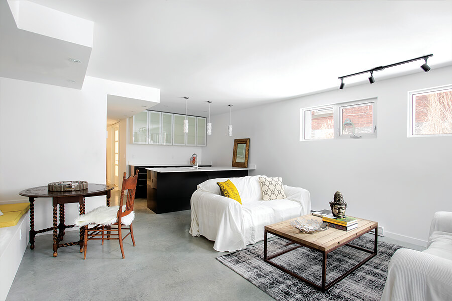 Image showing modern looking basement den with furnitute and a wet bar.