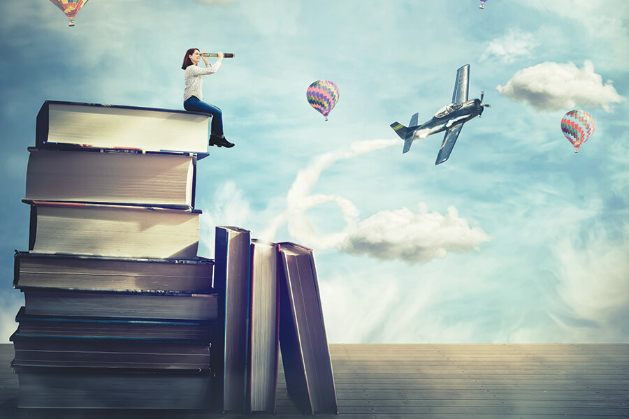 Image graphic showing a woman with a telescope sitting atop a pile of books with hot air balloons and a sport plane flying in the background.