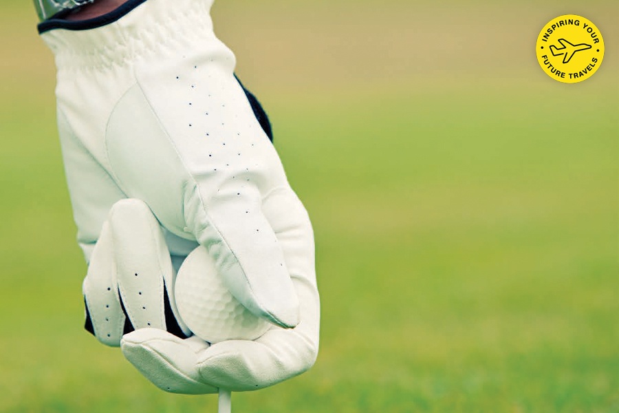 Image showing a hand clothed in a golfing glove holding a golf ball.