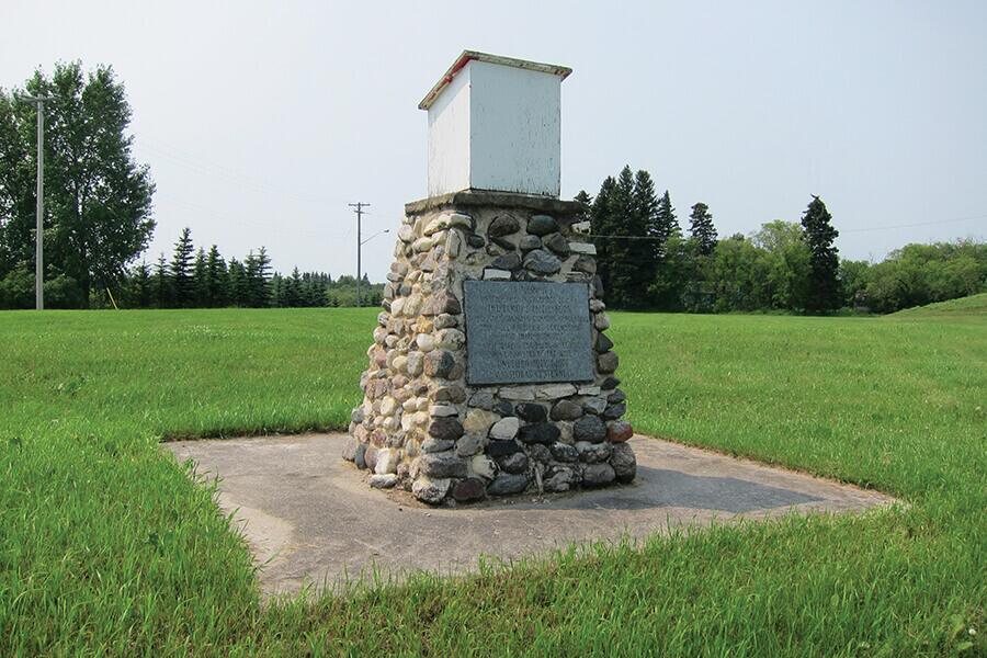 Image showing an outdoor toilet on top of a stone cairn.