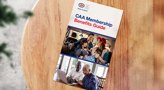 CAA Membership benefits digital guide on a table