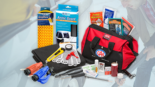 Photo featuring a roadside emergency kit with various products displayed in front of a red carrying bag.