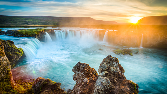 A waterfall during sunrise.