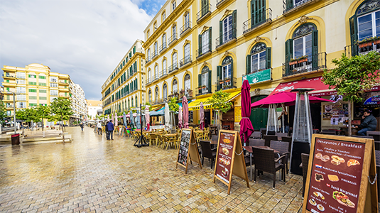 A row of restaurant patios in the Plaza de la Merced.