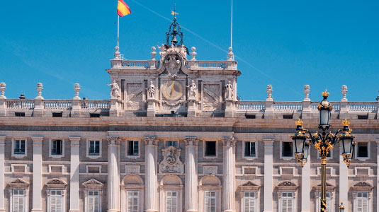 Front façade of the Royal Palace in Madrid on a sunny day.