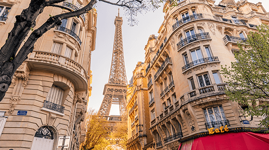 Eiffel Tower view from a Paris street on a sunny day.