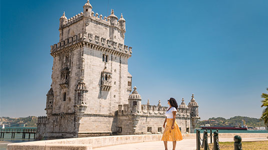 Woman in front of the Tower of Belem in Lisbon.
