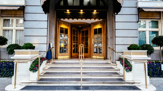 A hotel front with a grand entrance featuring gold doors.
