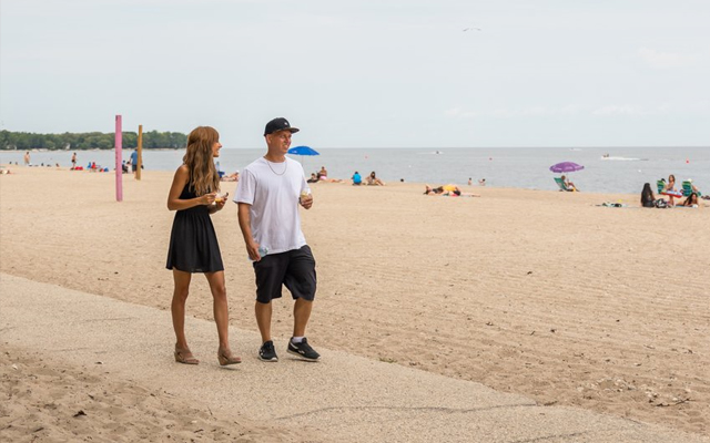 Image showing a young couple walking on the boardwalk along the shore of Lake Winnipeg at Gimli.