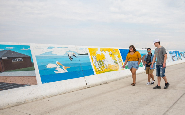 Image showing several people looking at the art works on the dock at Gimli.