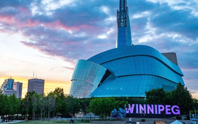 Image showing the exterior of the Canadian Human Rights Museum in early evening light.