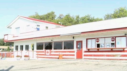 Image showing the exterior of a building painted white with red striped trim.