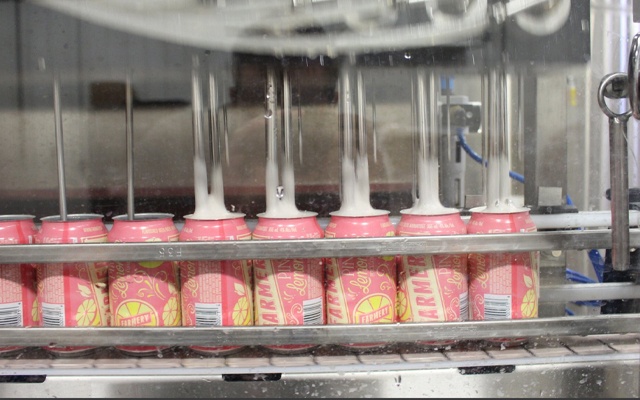Image of a brewery machine filling beer cans.
