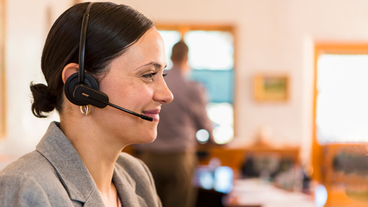 A female travel consultant with a headset on.