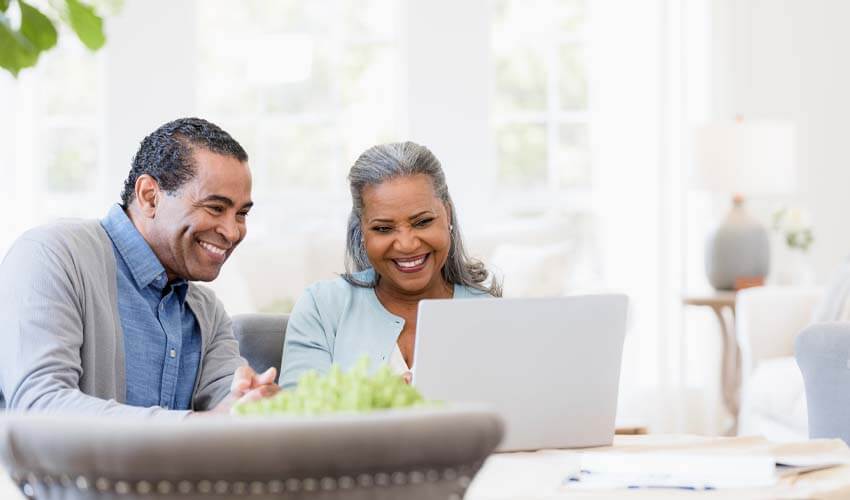 Grandparents planning their vacation on laptop