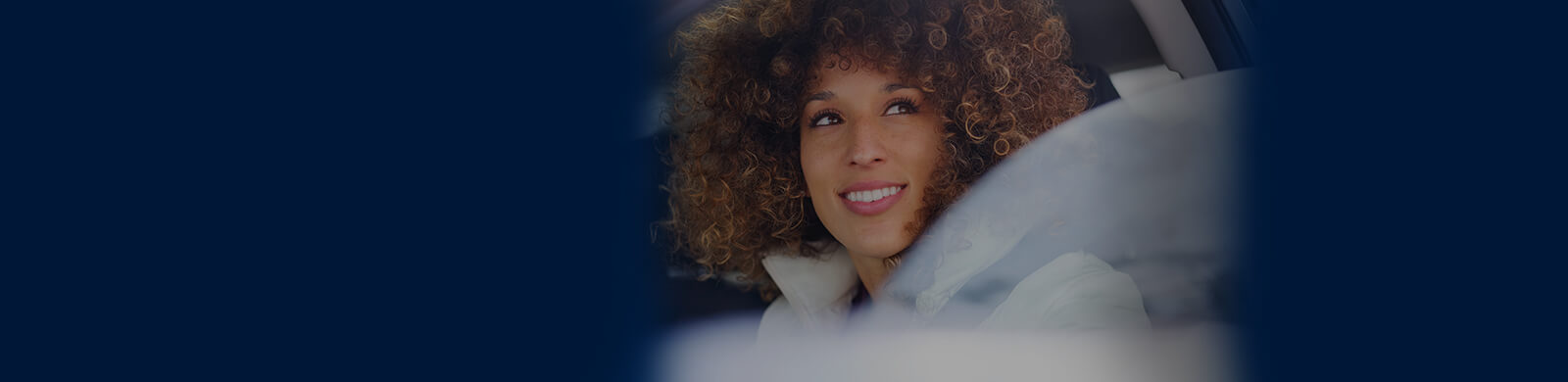Young woman enjoying a winter outing, driving her vehicle