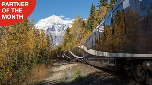 Rocky Mountaineer train with the mountains in the background. Partner of the month.