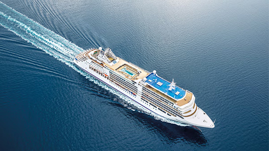 Silversea cruise ship sailing across water.