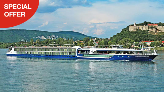 Avalon cruise ship on water passing an old small city. Special offer.