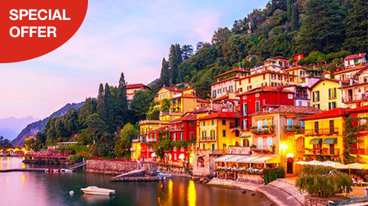 Colourful building within forest by the lake with mountains far away. Special offer.